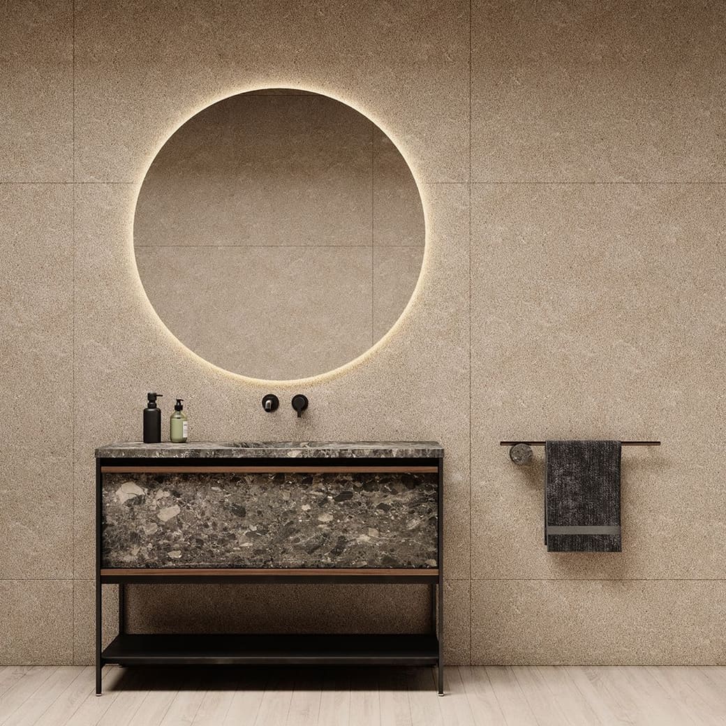 NORDIC METAL washbasin in dark stone on a black metal frame, below a round backlit mirror